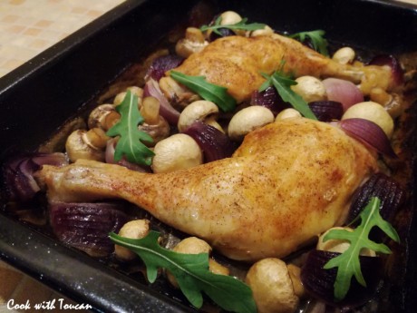 Roasted chicken legs with mushrooms and red onion