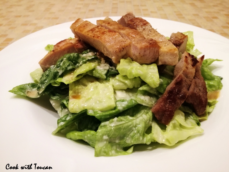 Pork steak and Roman salad with anchovy, Parmesan, olive oil and lemon juice