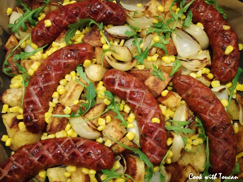 Roasted sausages with potatoes, onion and garlic